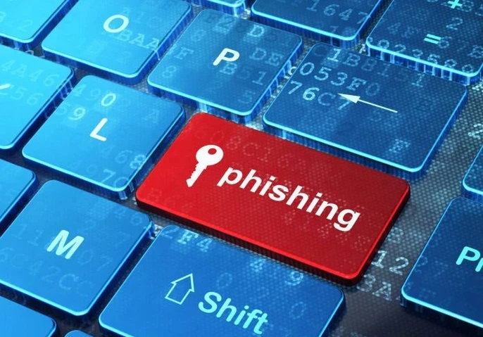 A keyboard with one of the keys showing the word "phishing" and a key icon.