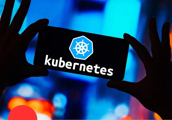 Hands holding up a smartphone with the screen displaying the word "Kubernetes"