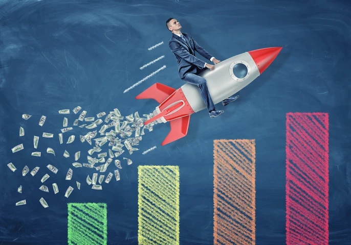 Man riding on a rocket on top of a graph.