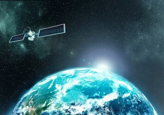 Image from space of a satellite floating above the Earth with the sun behind