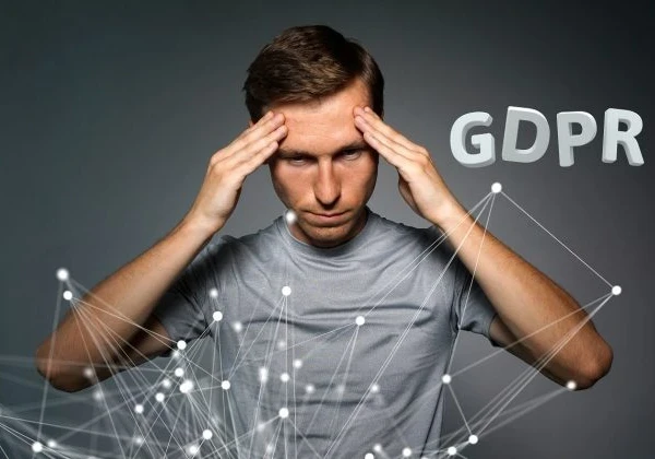 Man in a grey shirt standing in front of animated strings with the words "GDPR" in the background.