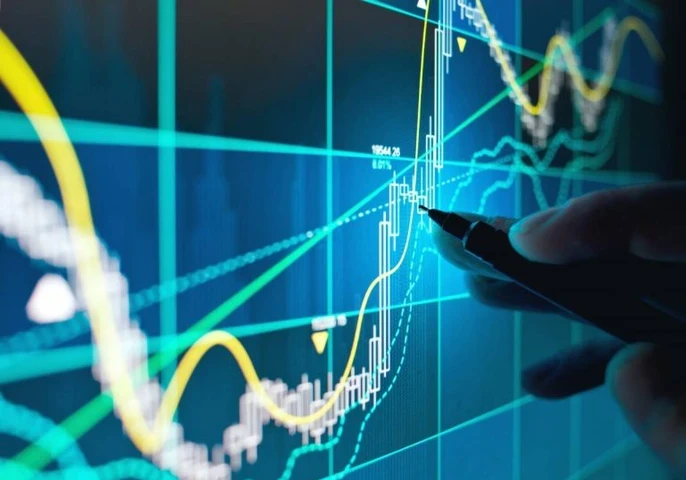 Hand using a pen to point at a graph on a screen.