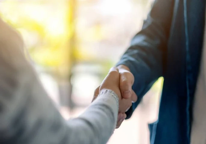 Two people shaking hands.