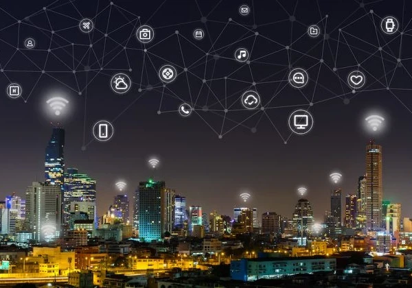Technology icons overlaid on a city skyline at night.