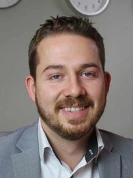 Profile picture of Rob Smith in a gray suit against a beige background.