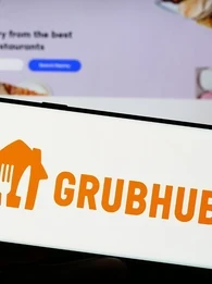 The GrubHub orange logo on a smartphone screen.