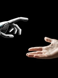 A robot hand and a human hand coming together.