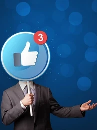 Image showing a man dressed in a suit holding up a large lollipop sign with a thumbs up emoji and sign for 3 unread notifications in Facebook branding