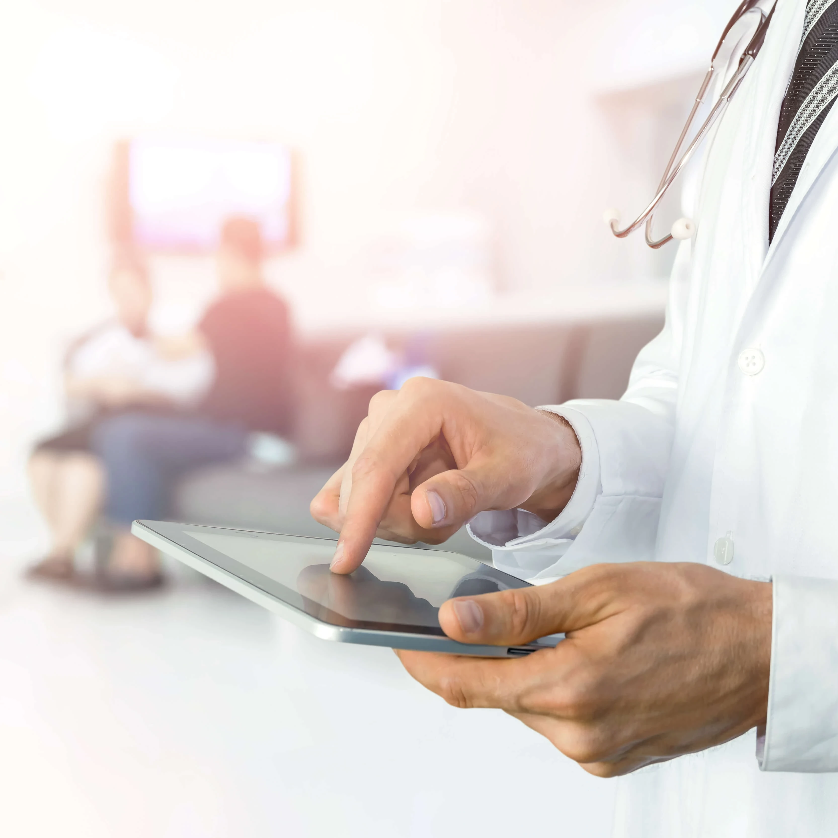 A doctor holding a tablet while patients wait in the background