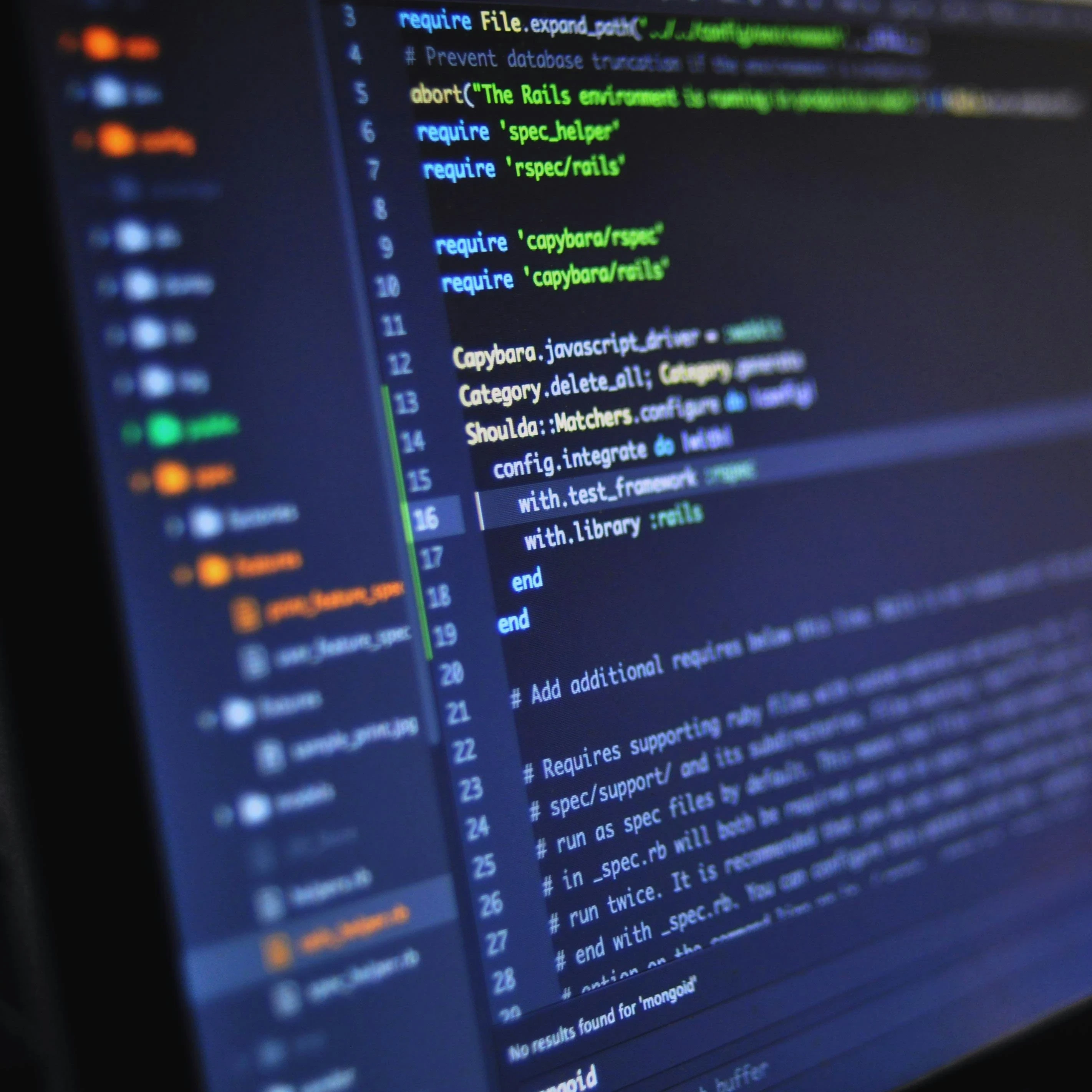 Code on a laptop screen in a dark room.