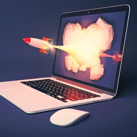 laptop showing a rocket flying out of the screen