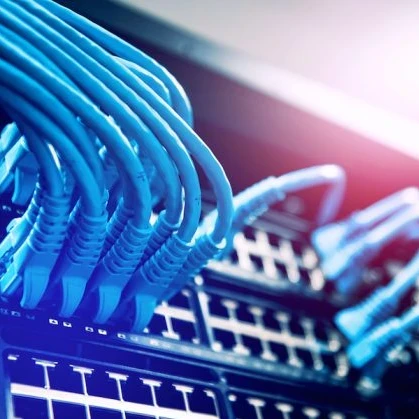 Image of IT cables in an IT server in blue and red lighting
